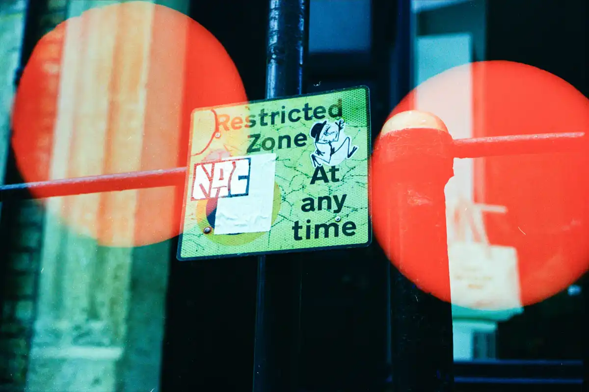 Restricted zone sign with red circular reflections