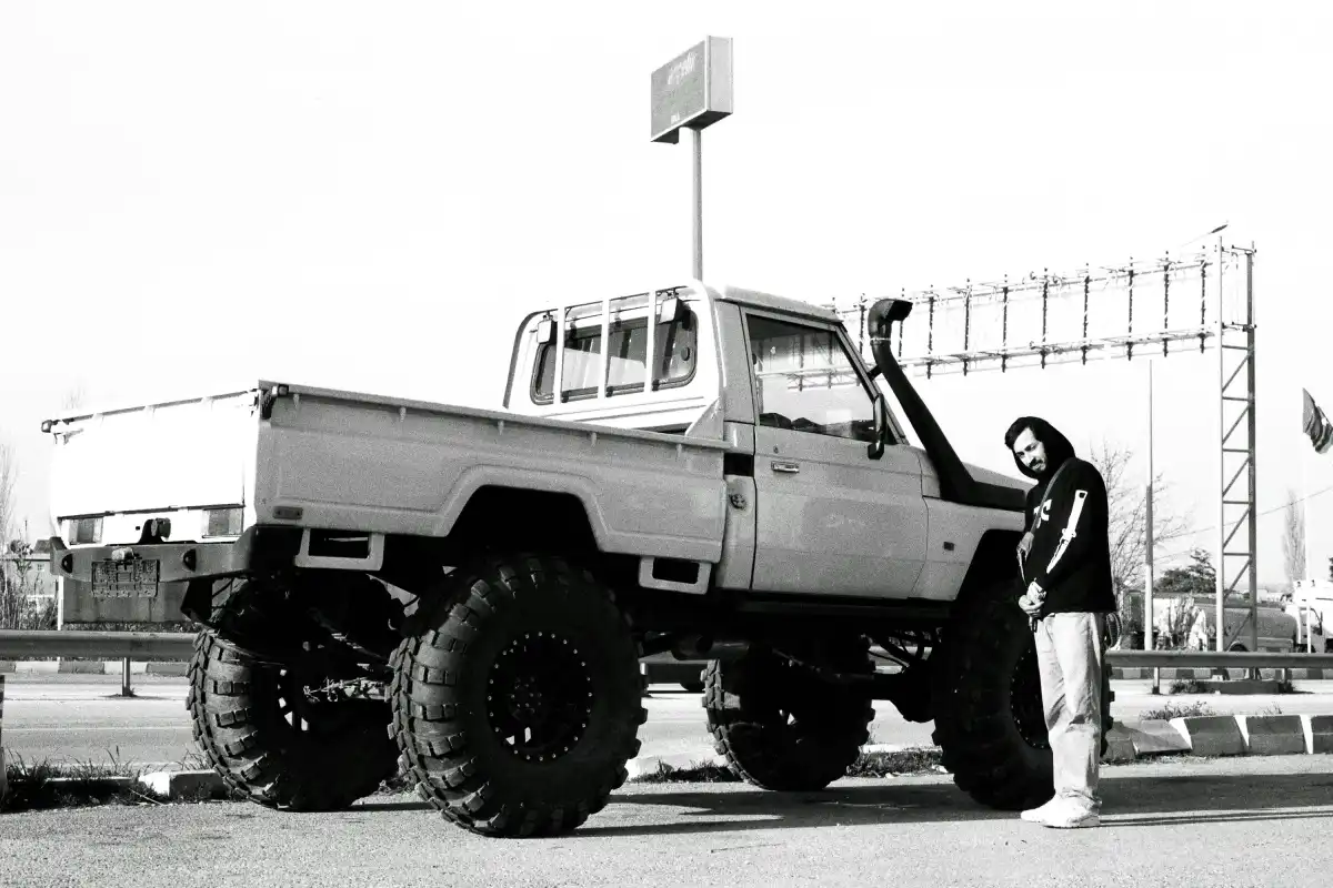 a man standing next to a white truck