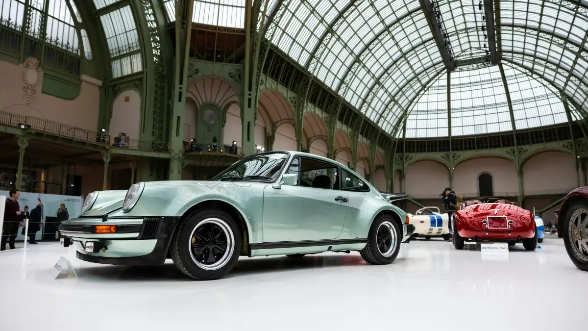 A group of cars parked inside of a building