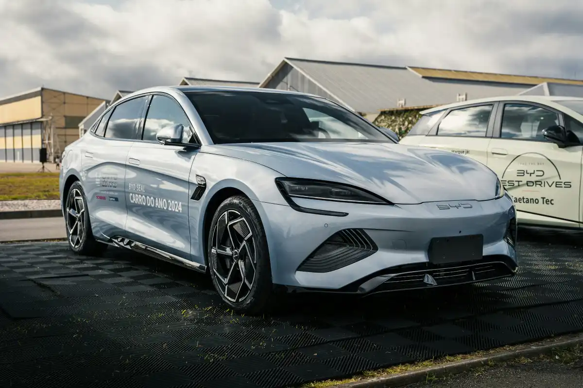 Two cars parked in a parking lot next to a building