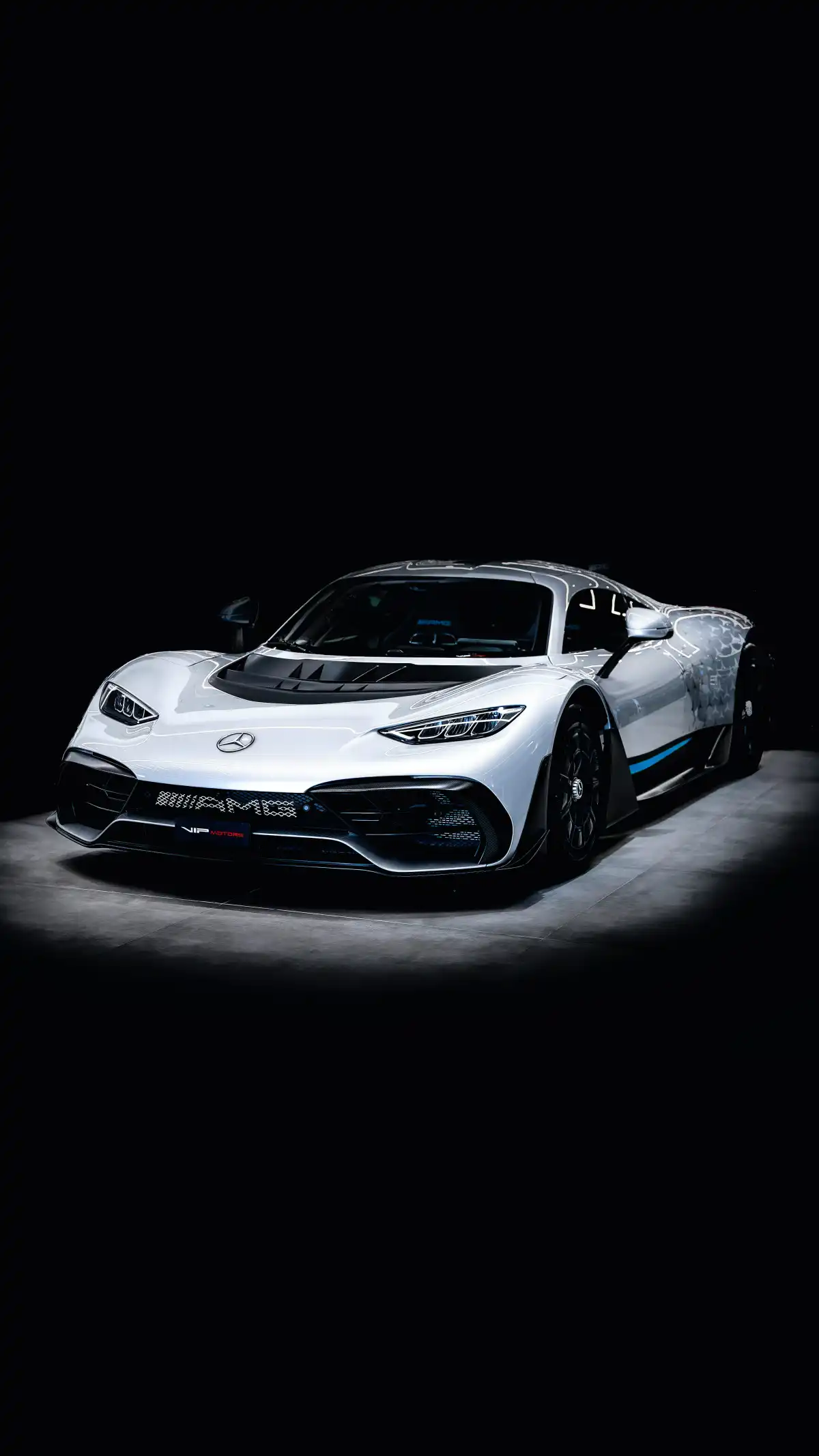 a white sports car in a dark room