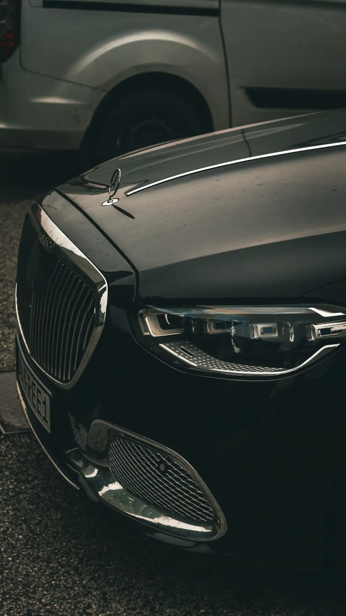 a black car parked next to a silver car