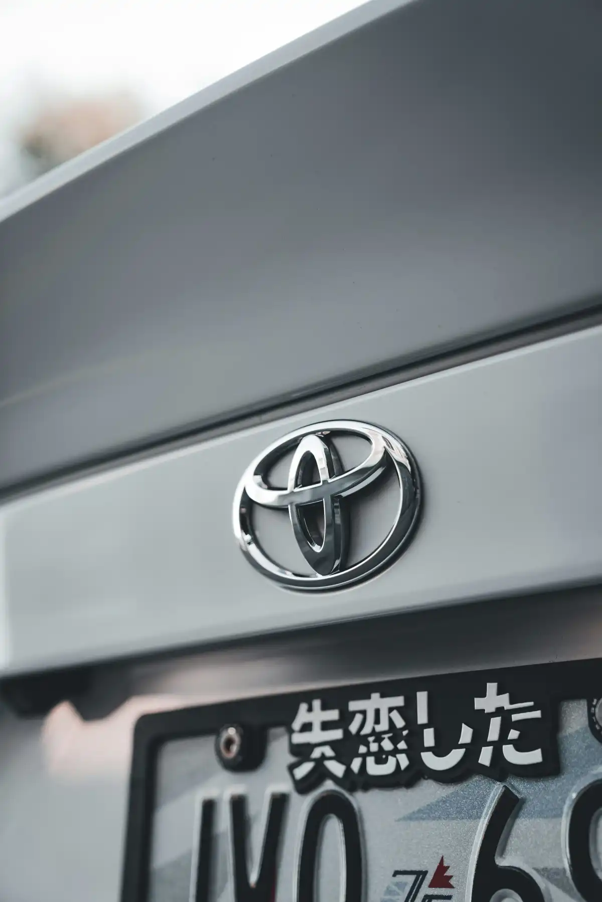 A close-up shows the toyota emblem on a car.