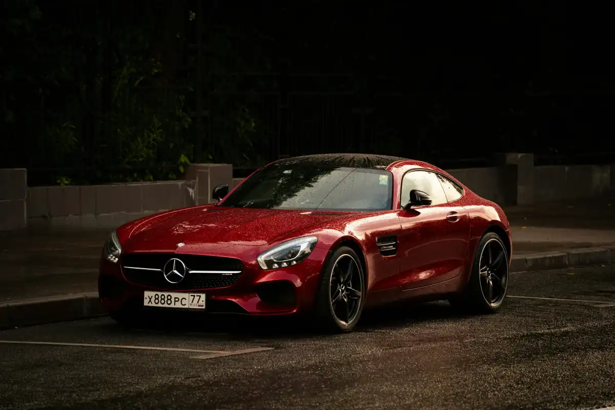 A red sports car parked on a dark street