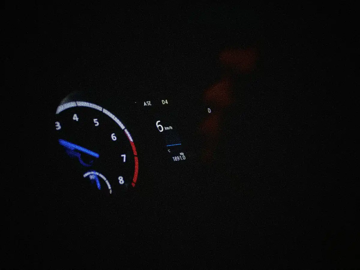 Car's speedometer lit up at night.