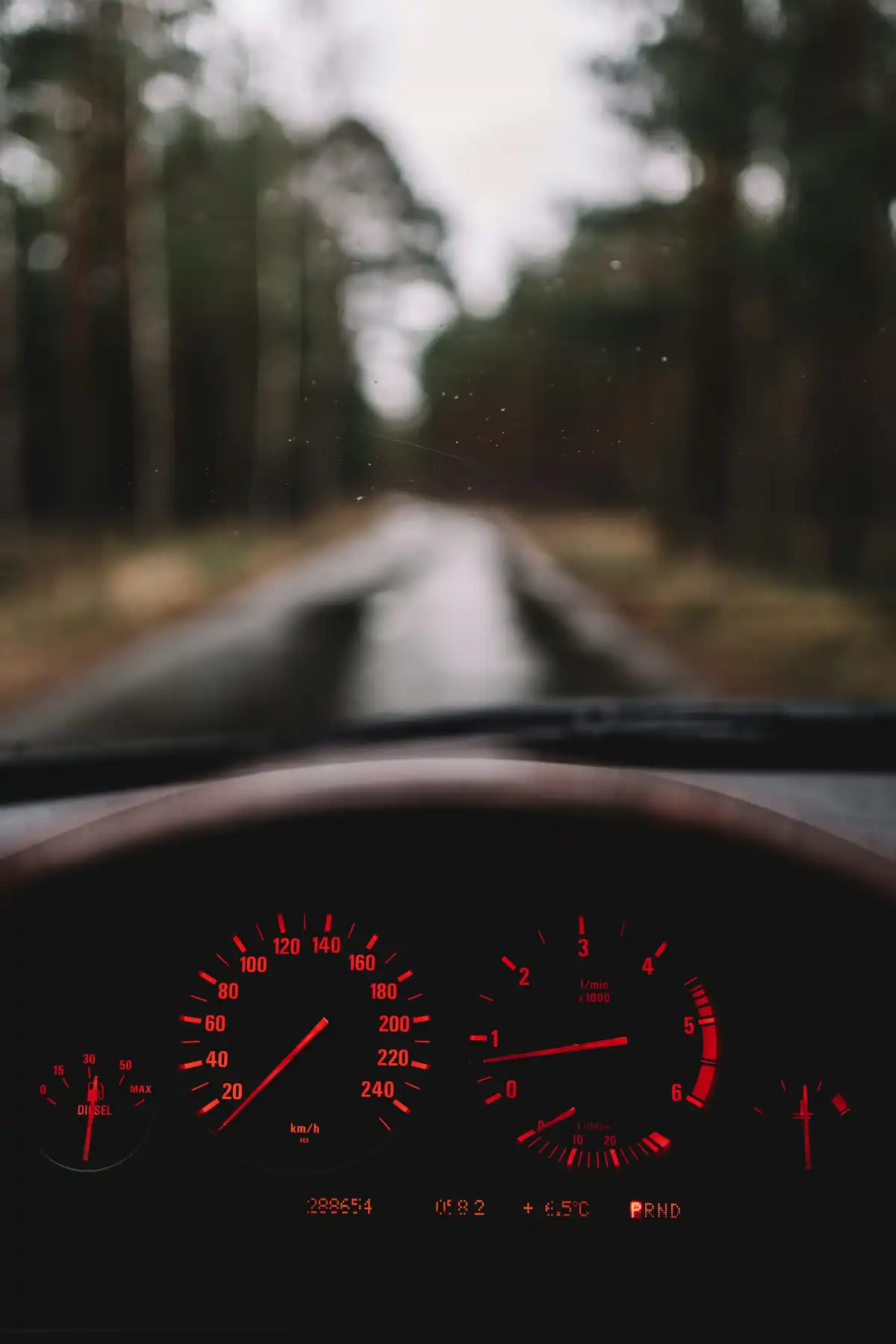 a car dashboard with a red light