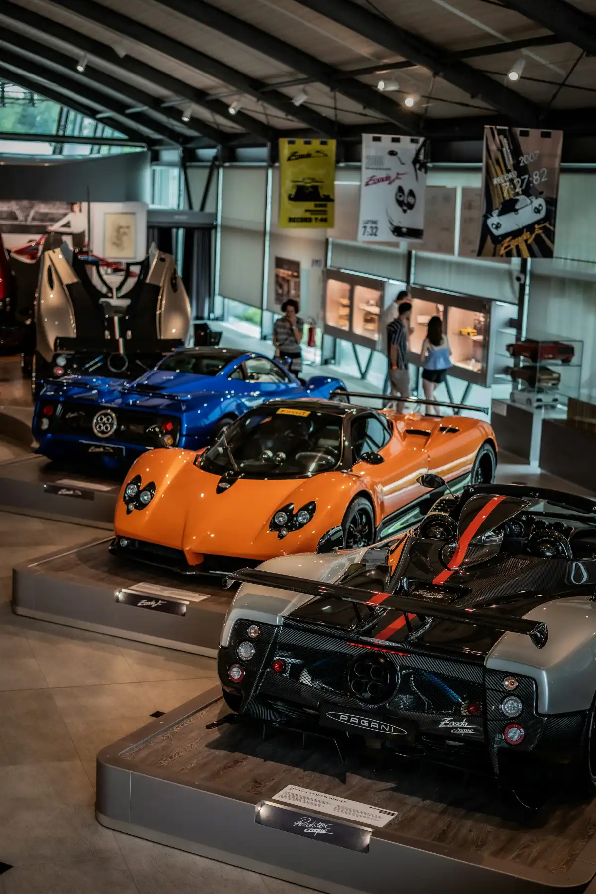 A group of cars are on display in a museum