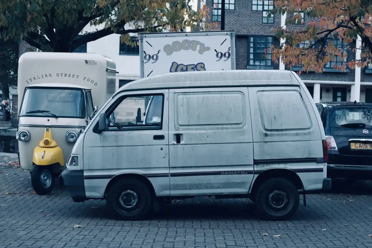 A van parked next to a yellow fire hydrant